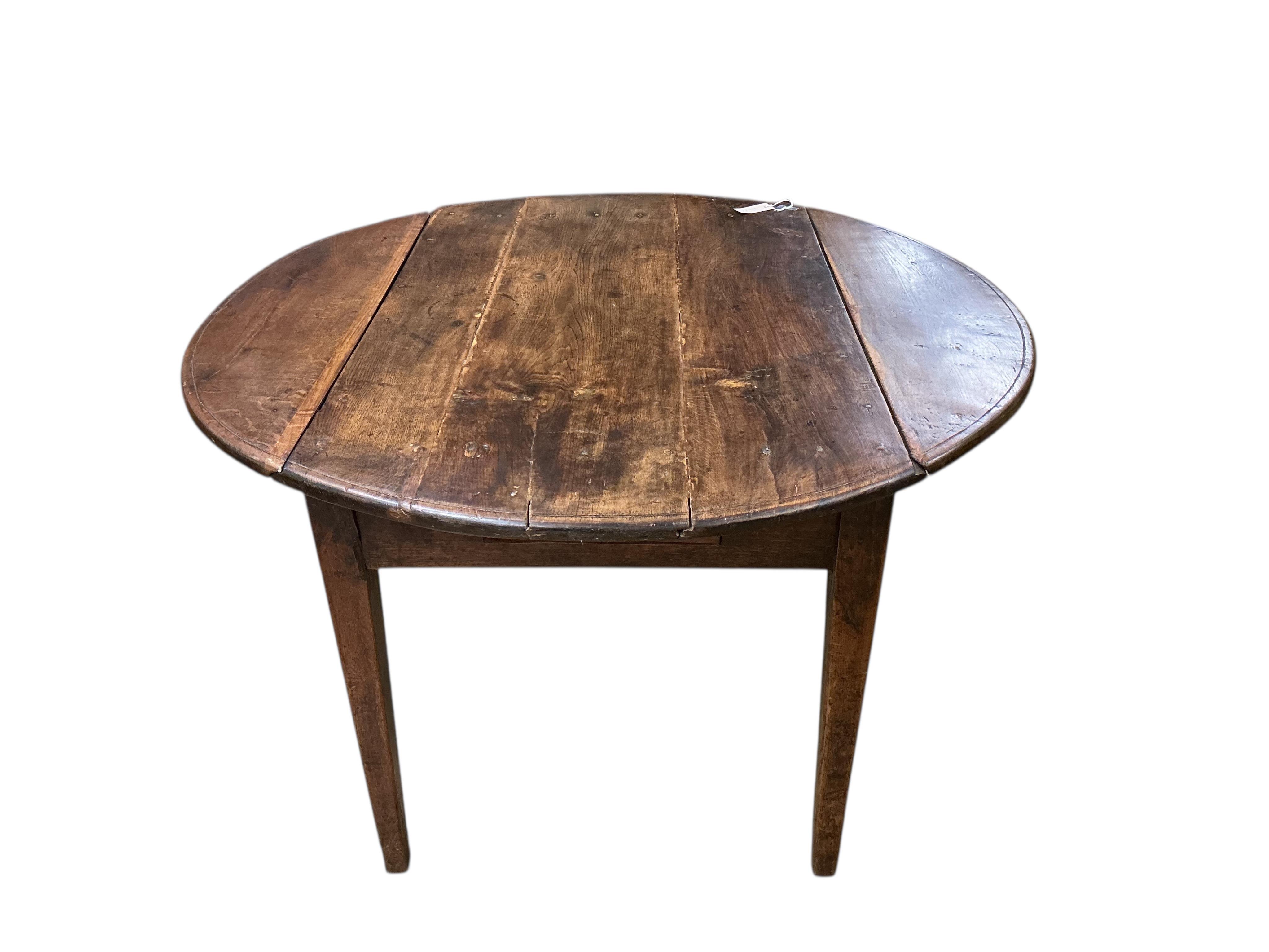 A 19th century French Provincial oak drop leaf table, width 122cm, depth 79cm, height 71cm